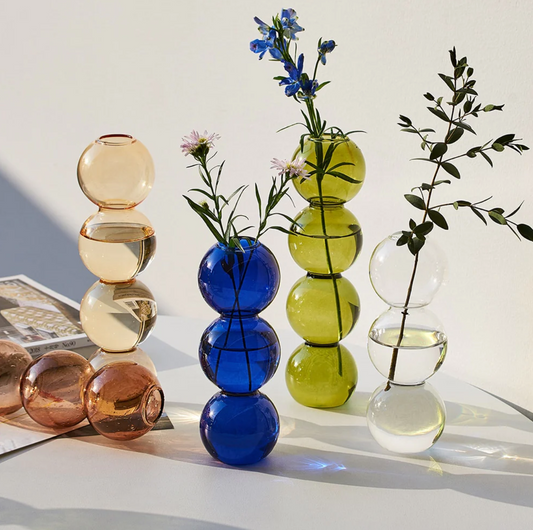 Abstract bubble glass vases add a gentle organic static beauty to brighten a room.